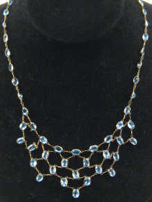 A blue topaz necklace set in yellow