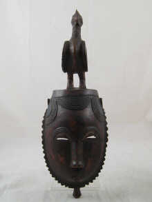 An African tribal mask surmounted with