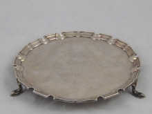 A silver waiter 25 cm dia. on three