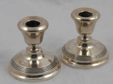 A pair of silver dwarf candlesticks