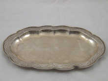 An oval silver dish with lobed