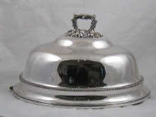 A large tall silver plated meat cover
