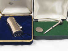 A silver propelling pencil in the form