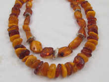 Two amber necklaces one with silver