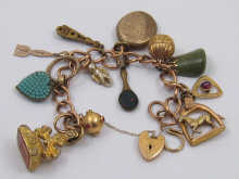 A yellow metal charm bracelet (