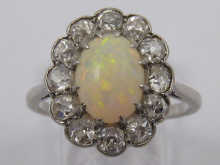 An opal and diamond ring set in