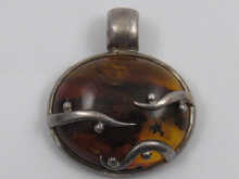 A silver mounted naturalistic amber