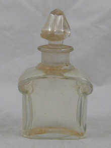 A Guerlain clear glass scent bottle