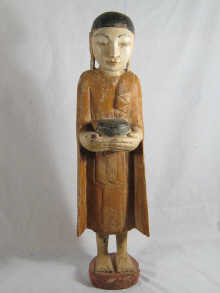 A carved and painted Oriental figure