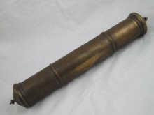 An Indian brass scroll holder containing