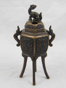 A Chinese bronze incense burner on four