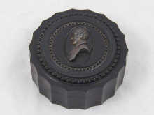 A 19th c. ebony circular box with