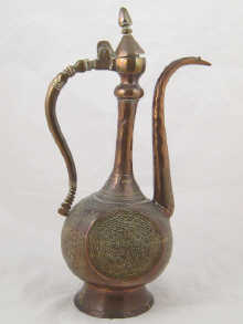 A large heavy copper Islamic ewer decorated