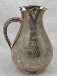 A Victorian silver water jug with engraved