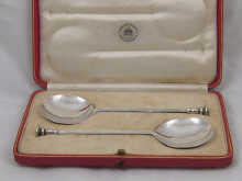 A boxed pair of silver seal top spoons