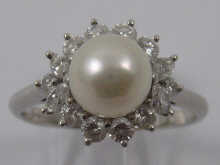 A platinum diamond and pearl ring by