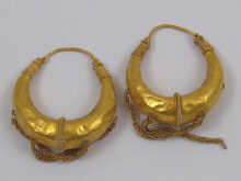 A pair of yellow metal tests high 14f5a0