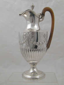 A silver wine ewer of half fluted design