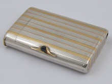 A silver cigarette case with vesta and