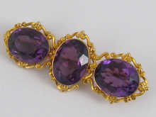 An exquisite three stone amethyst and