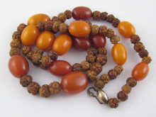 A carved wooden bead necklace interspersed