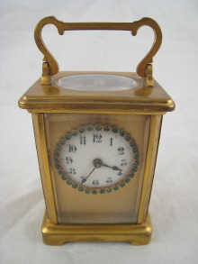 A brass carriage clock the circular