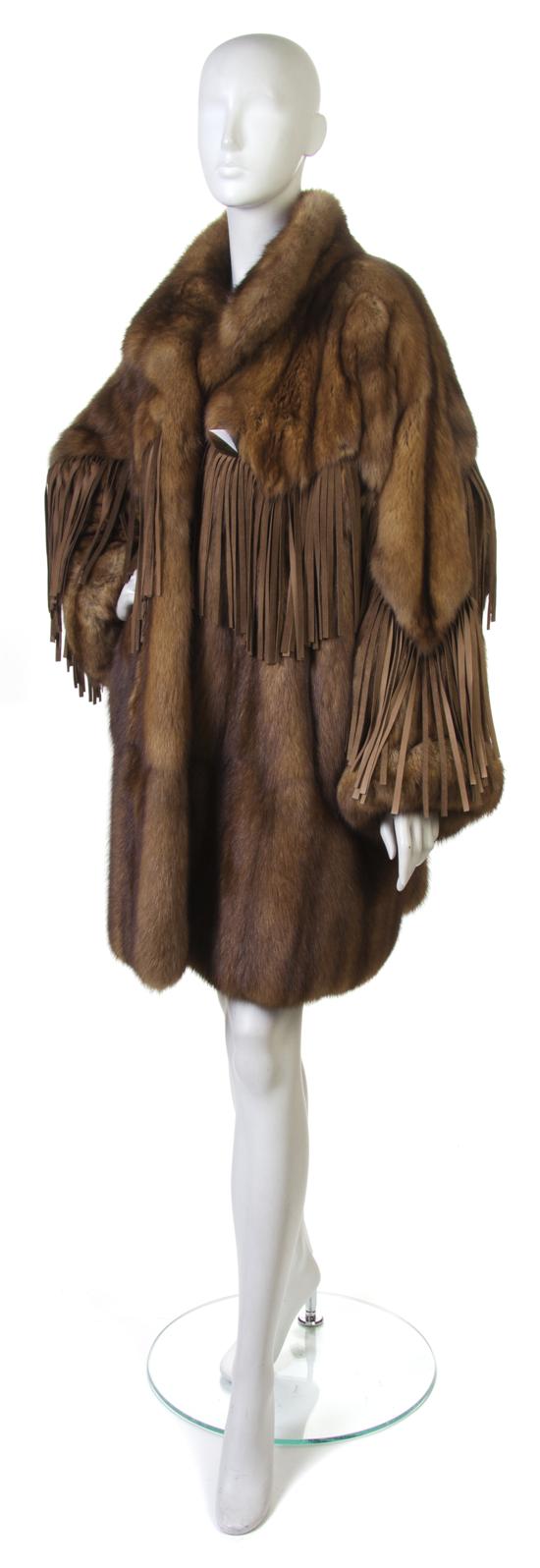 A Tan Sable Coat with fringe detail.