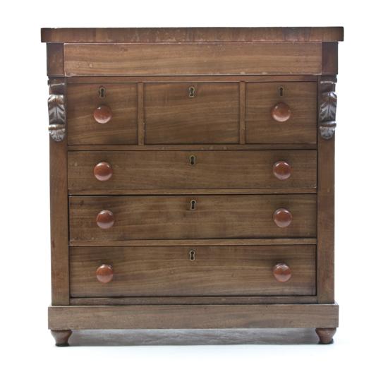 A Diminutive Walnut Chest of Drawers