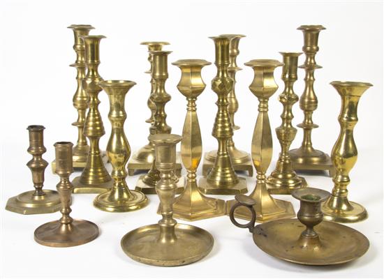 A Collection of Brass Candlesticks of