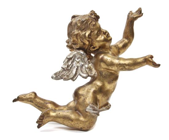 A Carved Giltwood Winged Putto