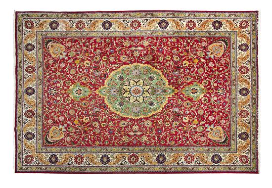 A Persian Tabriz Rug having a foliate