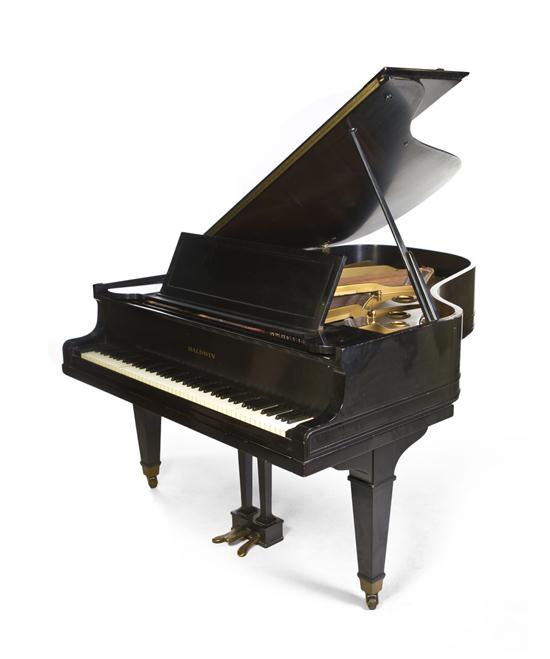 A Baldwin Baby Grand Piano in a black