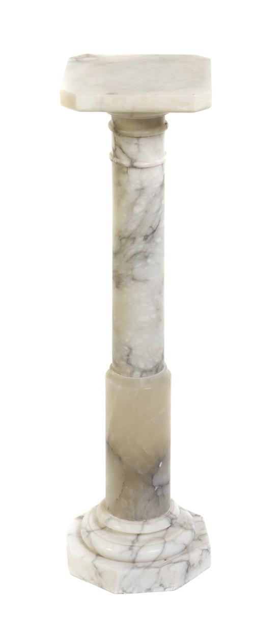 A Black and White Marble Pedestal having