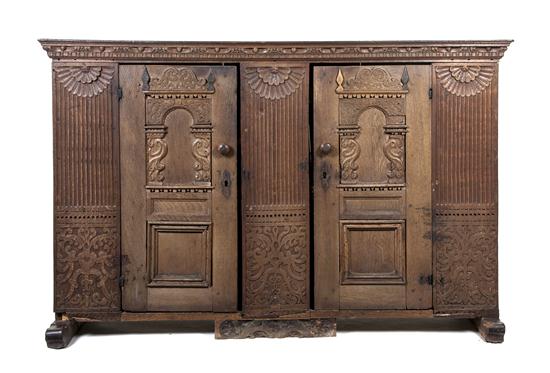 *A Continental Carved Oak Cabinet