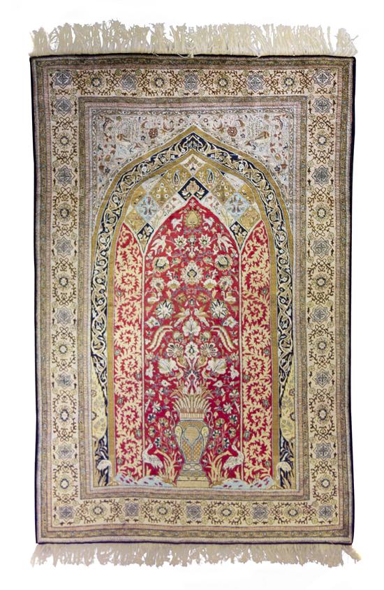 A Silk Prayer Rug having a central