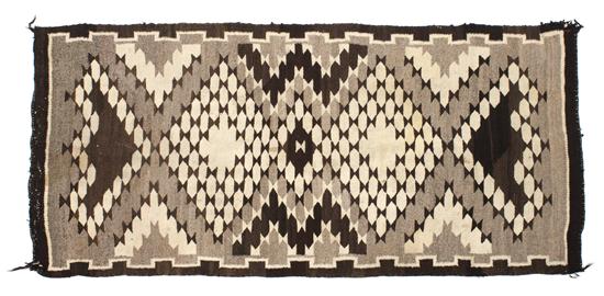 A Navajo Rug having a brown grey