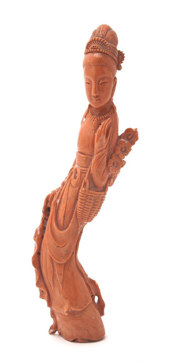 A Coral Carving of a Woman of deep orange