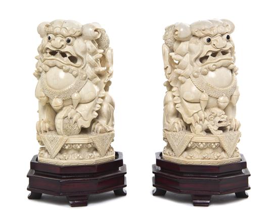 A Pair of Carved Ivory Fu Lions the