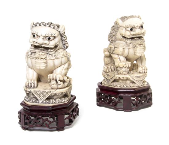 *A Pair of Carved Ivory Fu Dogs one