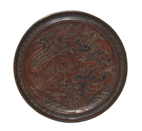 A Chinese Lacquered Bronze Mirror the