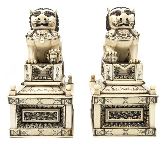 A Pair of Carved Ivory Fu Dogs