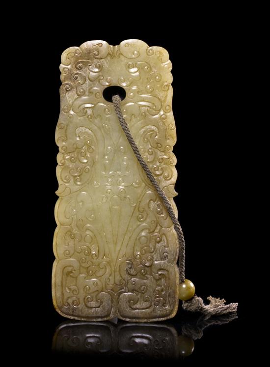 A Carved Jade Plaque of pale celadon