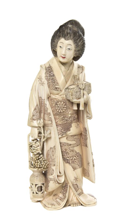 A Japanese Ivory Carving of a Woman