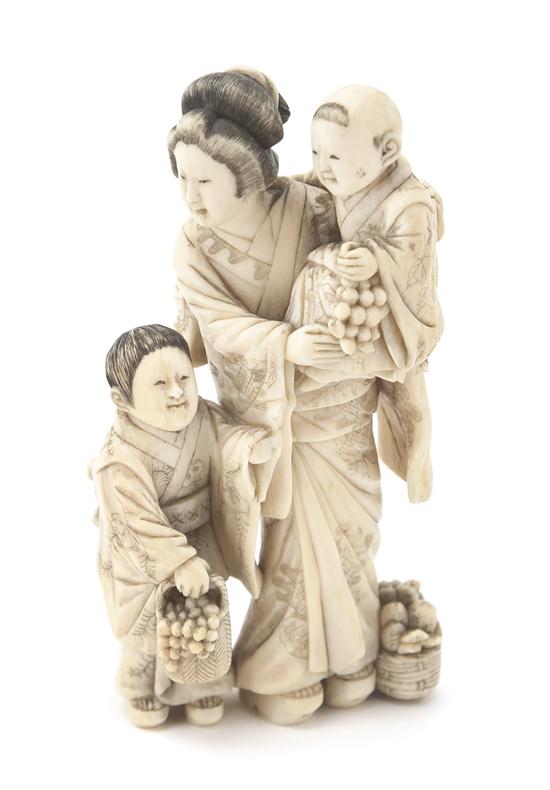 An Ivory Okimono of a Woman and Two