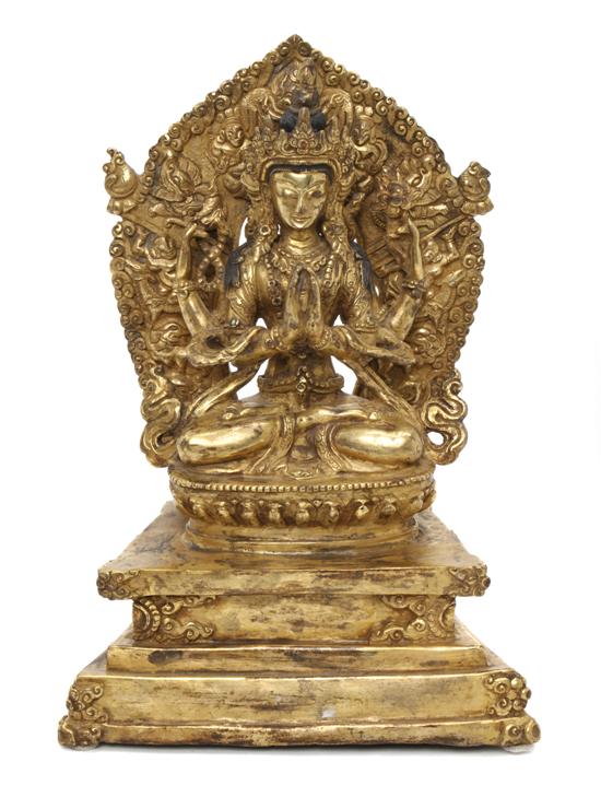 A Gilt Bronze Model of a Deity the multi-armed