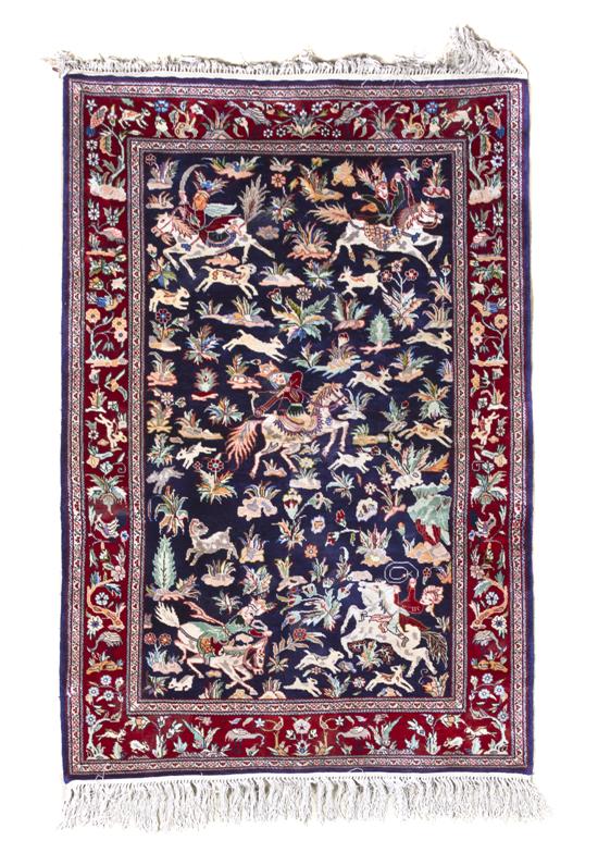 A Persian Silk Rug decorated with hunt