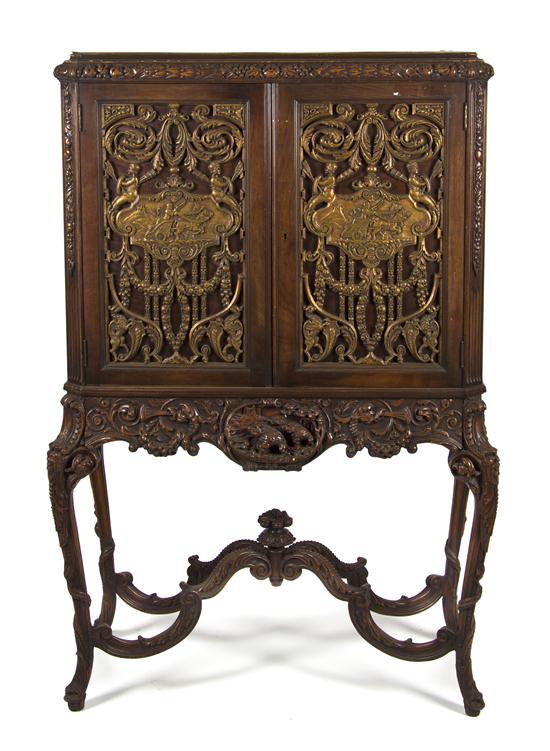 A Continental Cabinet on Stand the carved