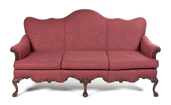 A Victorian Camelback Sofa having