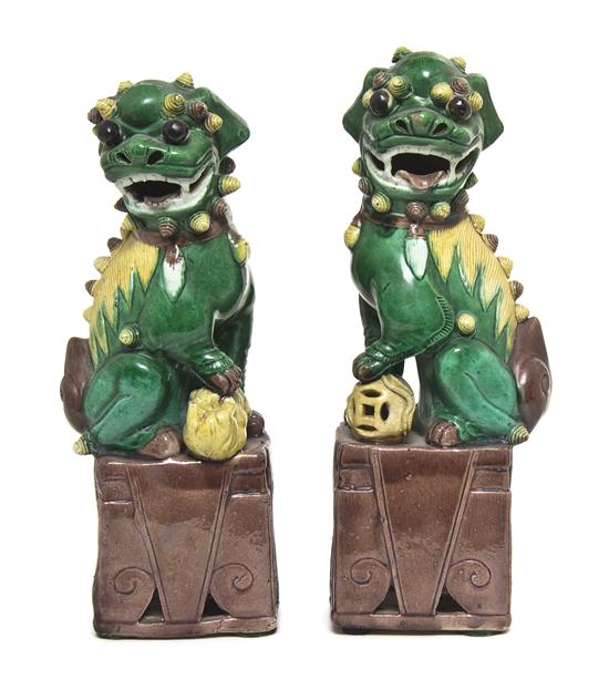 A Pair of Porcelain Fu Dogs with green