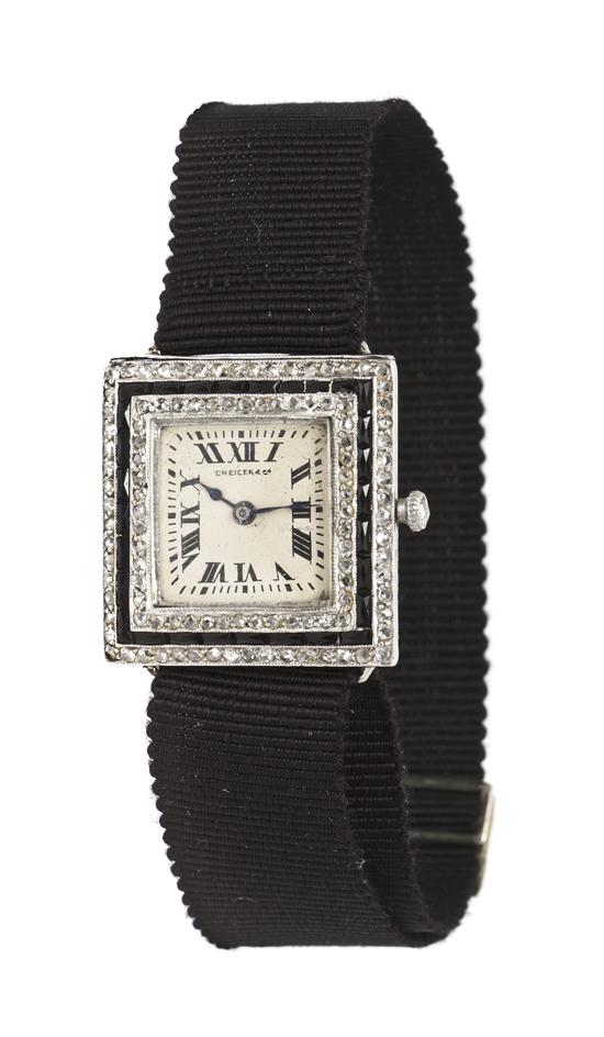 A Platinum Onyx and Diamond Wristwatch